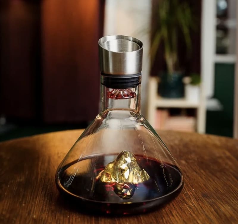 decanter tad-deheb ta 'lussu għall-inbid aħmar bil-muntanji ġewwa